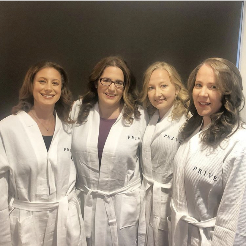 group of women with their mobile hair and makeup done