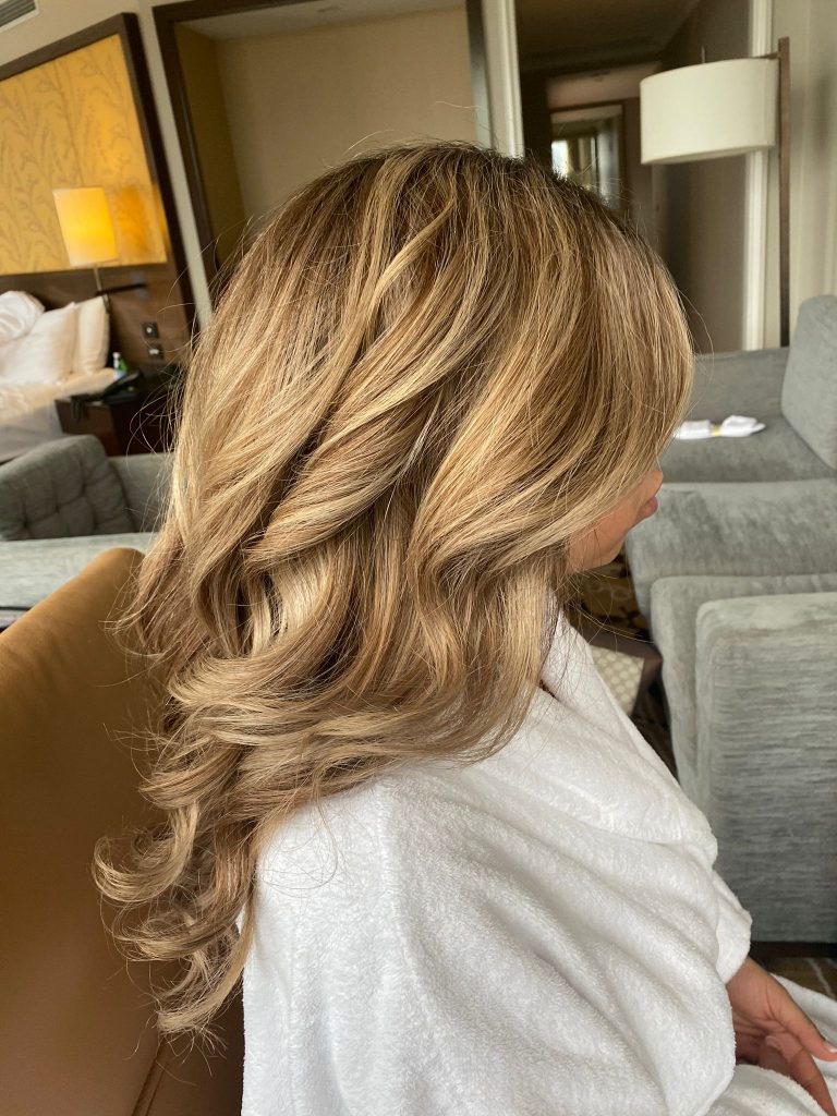side view of the bride with her hair and makeup done