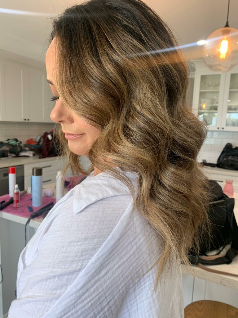 bride with a long and wavy hairstyle done by a wedding hairstylist